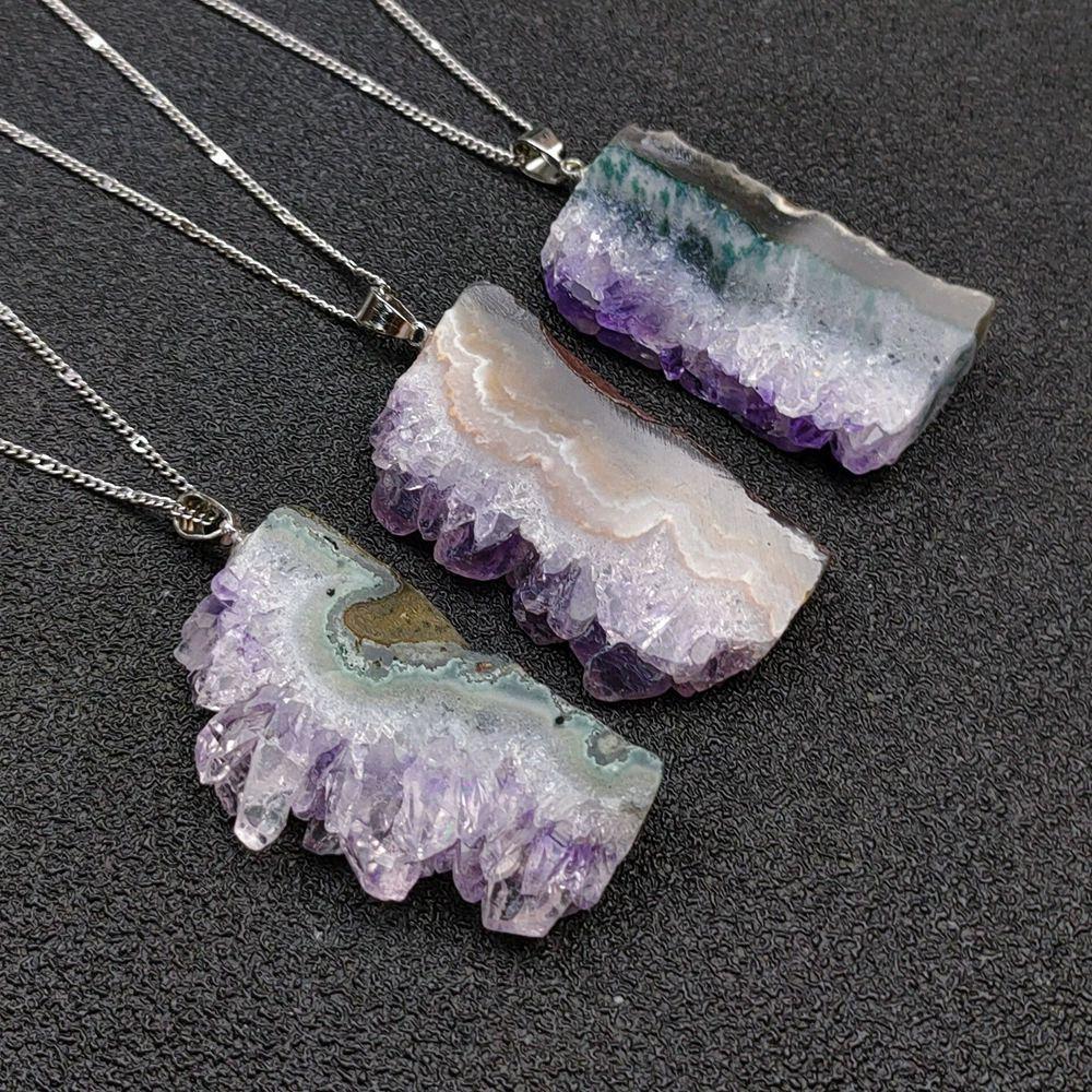 Hand-sculpted raw amethyst pendant close-up - Primal energy necklace for chakra balancing and nature elegance