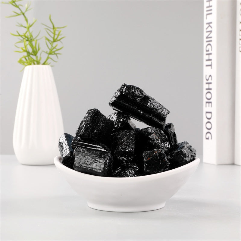 Black Tourmaline stone blocking EMF radiation near laptop and router - Protective crystal for tech professionals