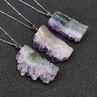Hand-sculpted raw amethyst pendant close-up - Primal energy necklace for chakra balancing and nature elegance